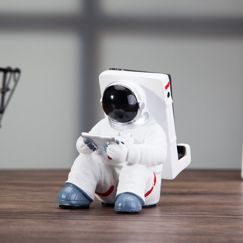 Space Spaceman Mobile Phone Desk Holder on a desk with a phone for home decor ideas